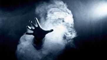Hand reaching out of smoke