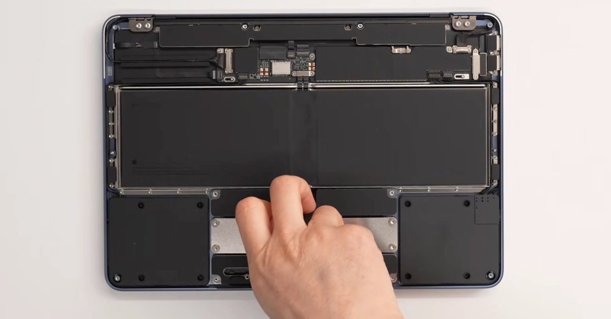 Inside MacBook Neo shows a little computer and a lot of battery, speakers, and trackpad